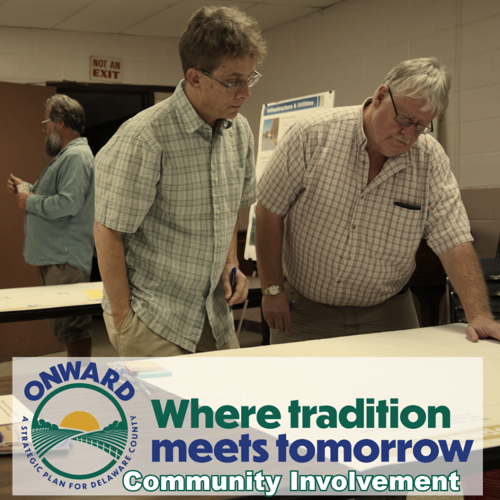 Brochure Value-10-#5 Two workshop participants looking at presentation board.